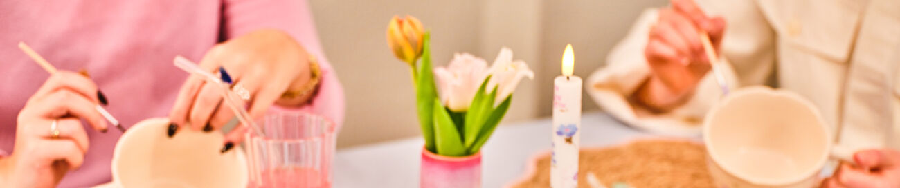 mom and daughter painting tea cups